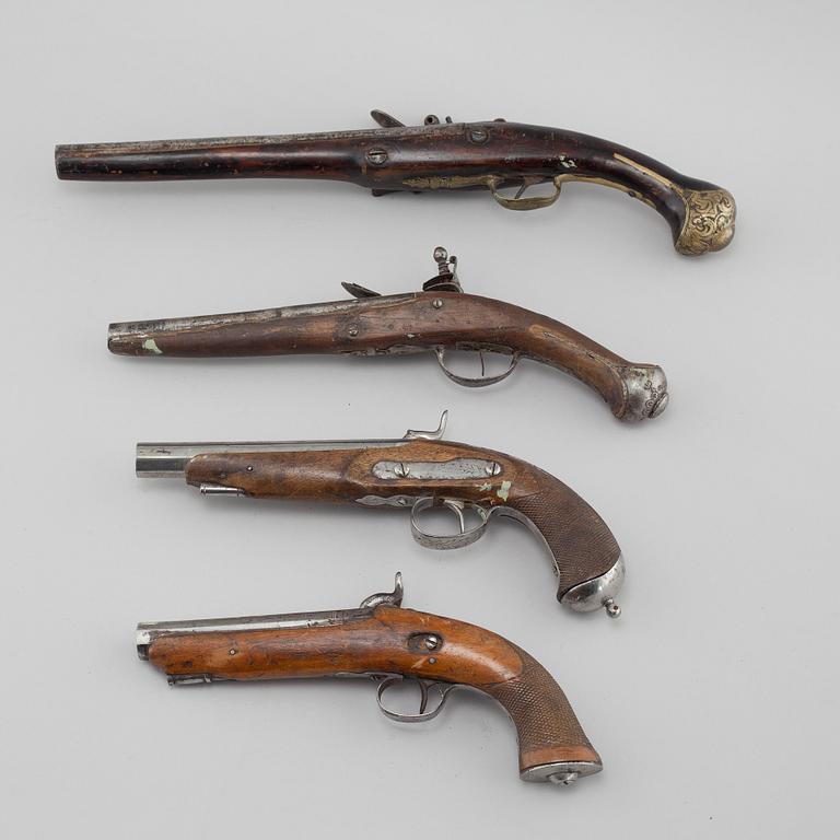 Four percussion and flintlock revolvers from the late 18th century / 19th century.