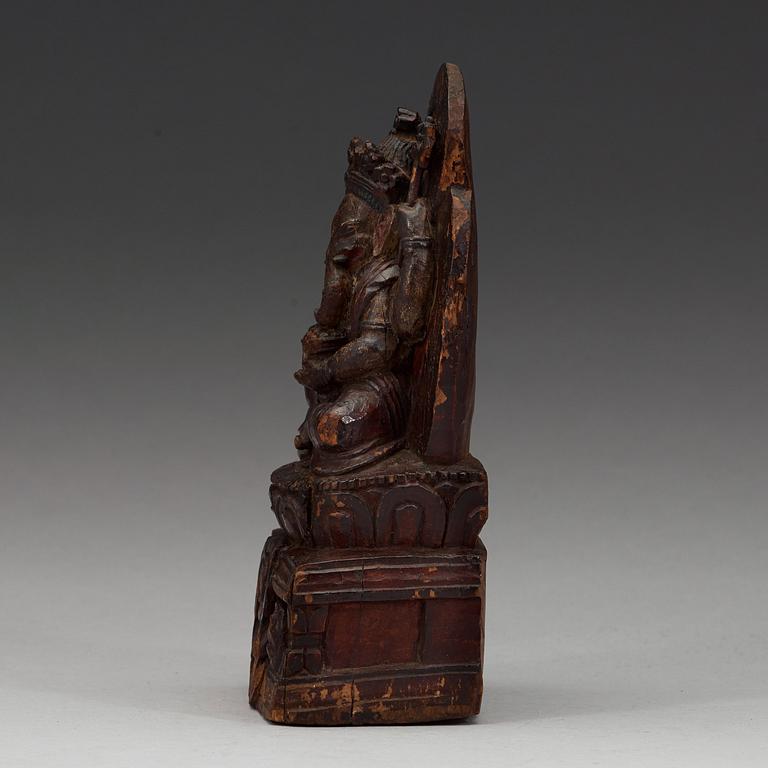 A carved wooden figure on Ganesha on a throne, Nepal, 19th Century or older.