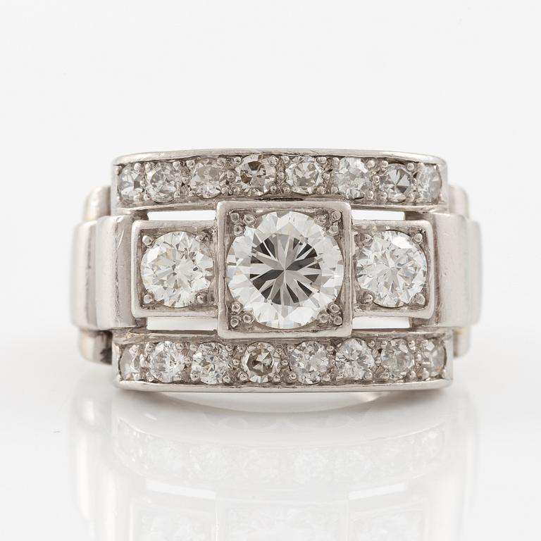 A platinum ring set with round brilliant and old-cut diamonds.