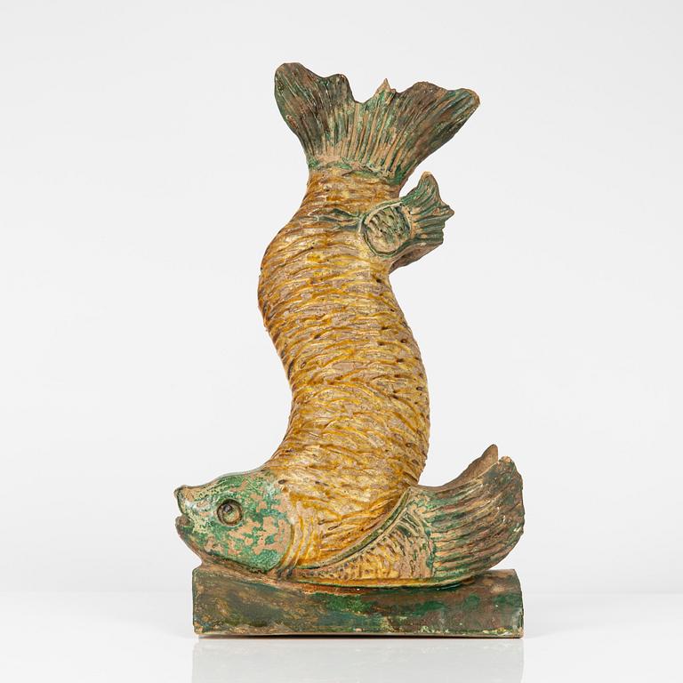 A green and yellow glazed roof tile figure of a fish, Ming dynasty (1368-1644).