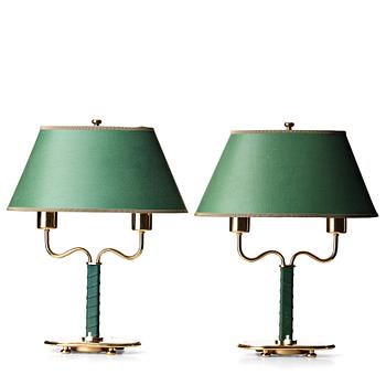 100. Josef Frank, a pair of brass and green leather table lamps, Svenskt Tenn, model 2388.