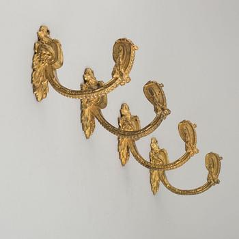 Four 19th century bronze tie-backs.