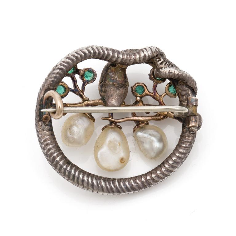 A Karl Rothmüller, Art Nouveau serpent brooch, circa 1900, with a ruby, emeralds and probably natural saltwater pearls.