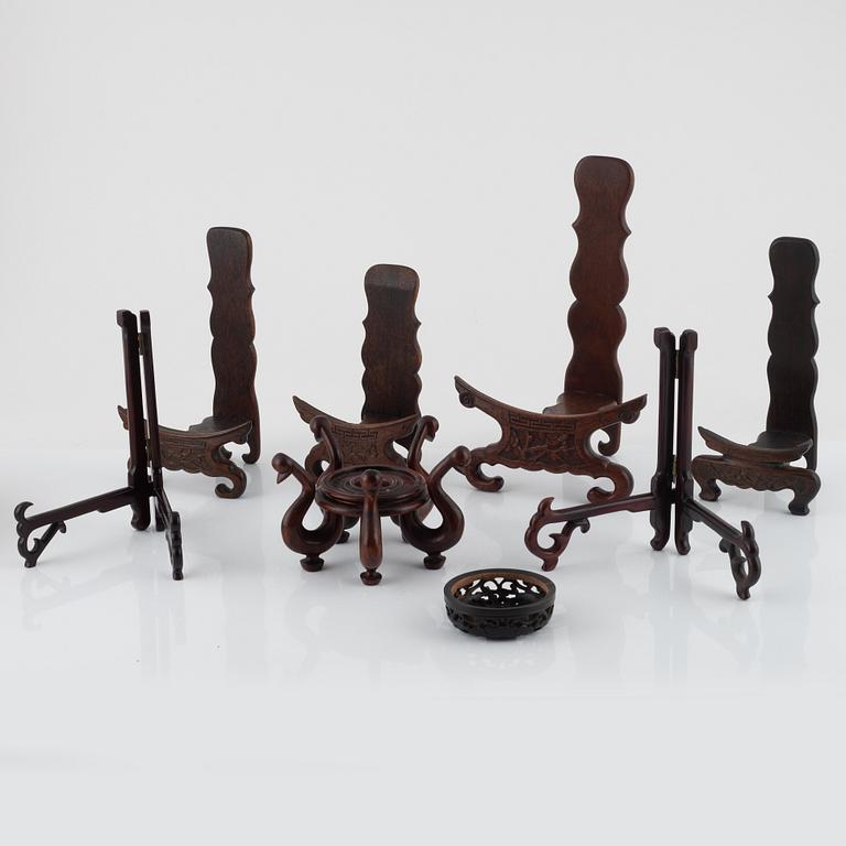 Seven hardwood stand for plates and vase, and one lid, China, 20th century.