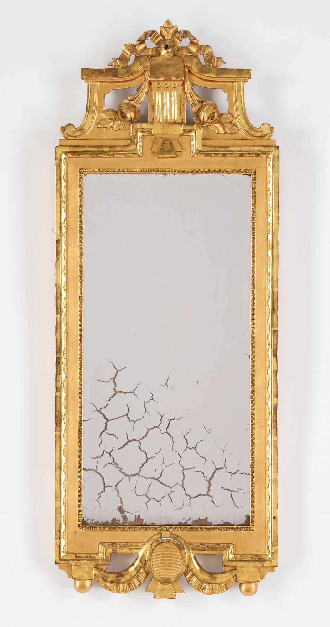 A gustavian giltwood and parcel-gilt mirror by Johan Åkerblad (master 1758-1799).