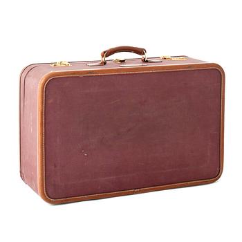 703. T ANTHONY Ltd, a aubergine canvas suitcase from the 1970s.