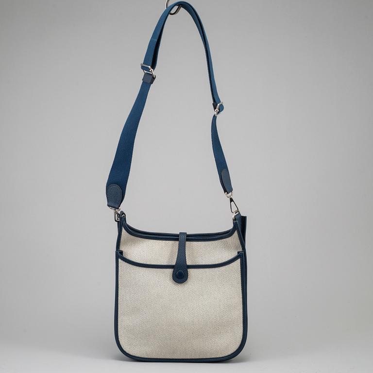 HERMÈS, a canvas and blue leather crossbody bag, "Evelyn".