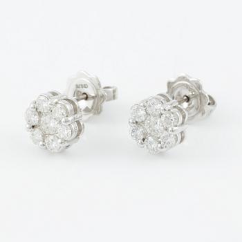 A pair of earrings in 18K white gold set with round brilliant-cut diamonds.