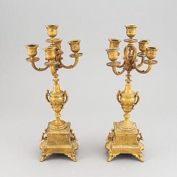 A late 19th century table clock and candelabra, probably France.