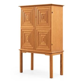 151. A Swedish Modern oak cabinet on stand attributed to Oscar Nilsson, 1940's.