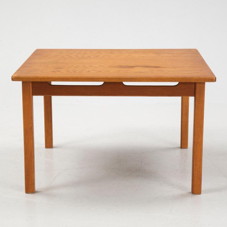 An oak coffee table with a later travertine top.