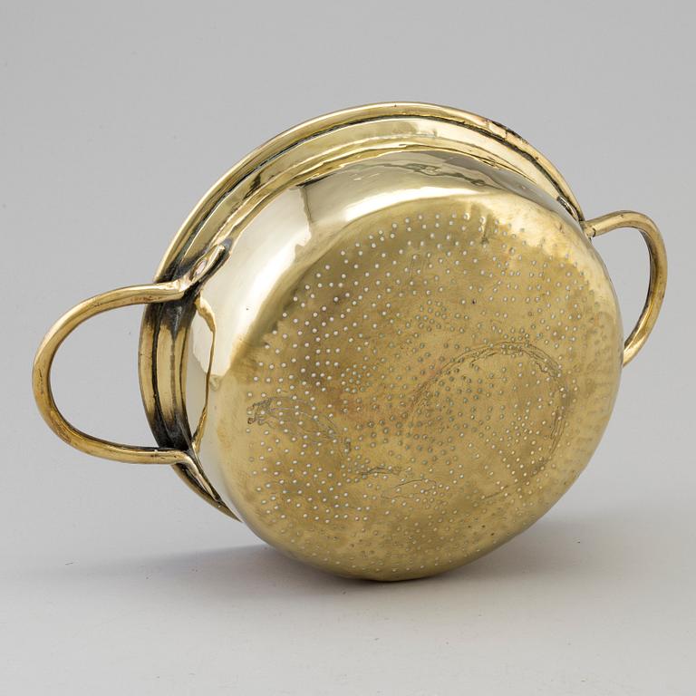 An 18th century brass colander.