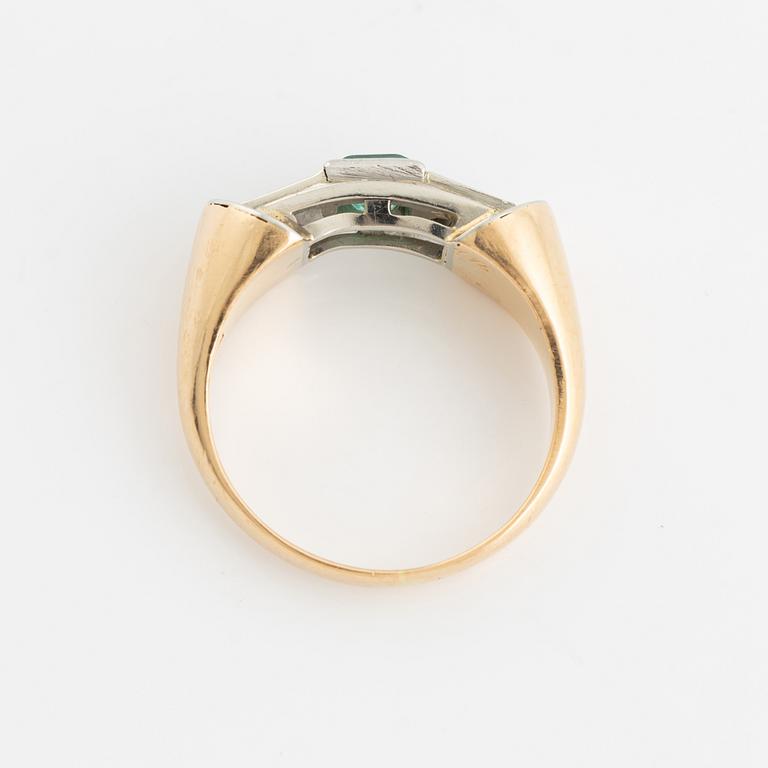 An 18K gold ring set with a step-cut emerald and round brilliant-cut diamonds.