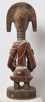 A sculptue and two masks reportedly from The Ivory coast, from the second half of the 20:th century.