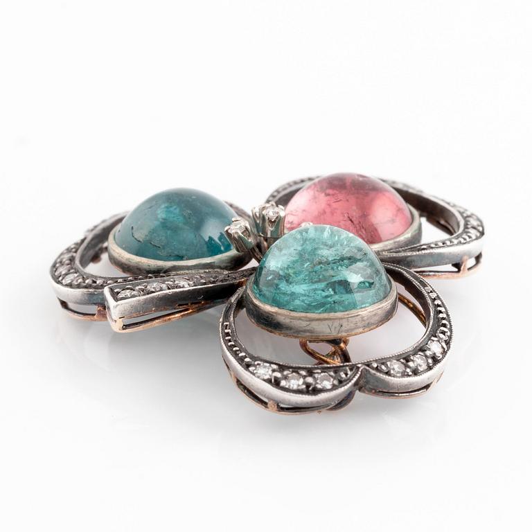 A silver and 18K gold brooch set with cabochon-cut tourmalines.