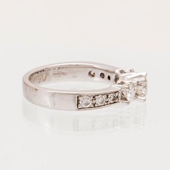 An 18K white gold ring set with round brilliant cut diamonds.