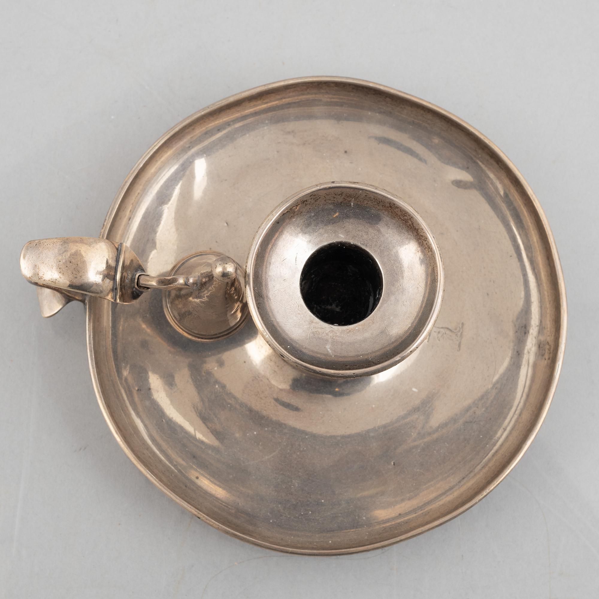 A silver chamber candlestick with mark of R & S Garrard & Co, London, England 1848.