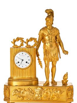 An Empire mantel clock, first part of the 19th century .