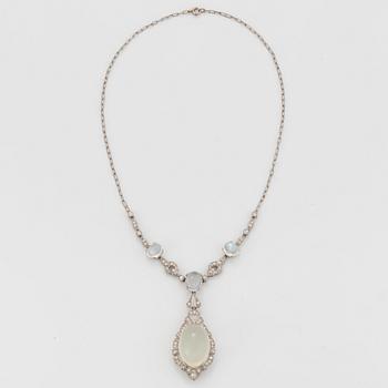 A platinum necklace set with moonstones and old- and eight-cut diamonds.