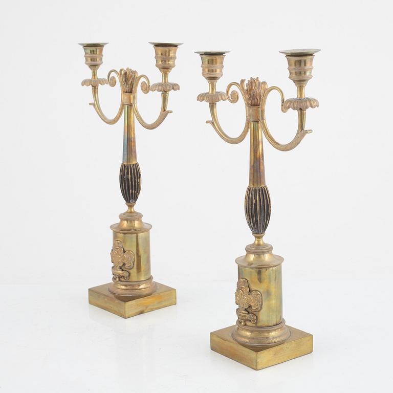 A pair of Swedish Empire two-branch gilt-brass candelabra, 1820's/30's.