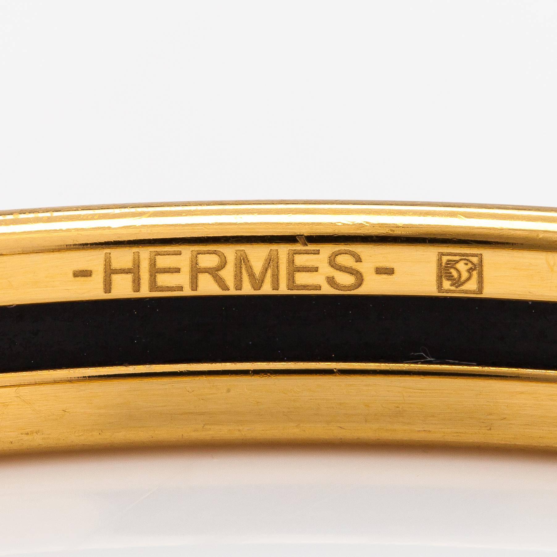 Hermès, a bracelet made of gold coloured metal and green enamel. Marked Hermès Paris, Made in France.