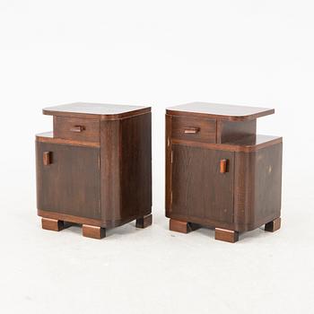 A pair of stained wood bedside tables from the first half of the 20th century.