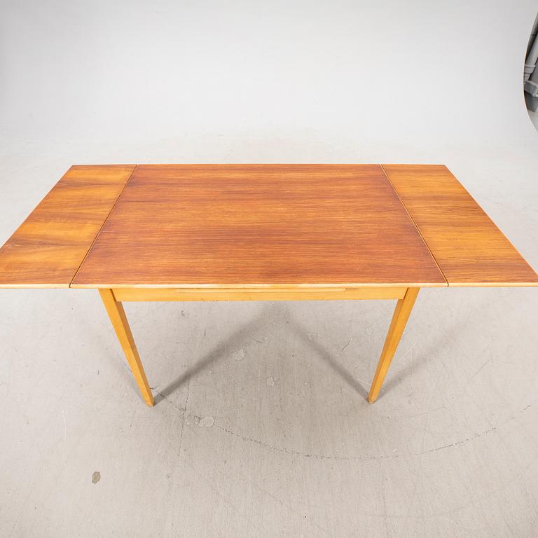 A 1960s teak and beech dining table.