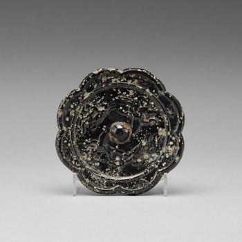 449. Eight-lobed bronze mirror with  mythical animals,  Tang dynasty (618–907).