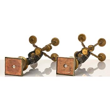 A pair of Fernch Empire ormolu and patinated bronze five-light candelabra, early 19th century.