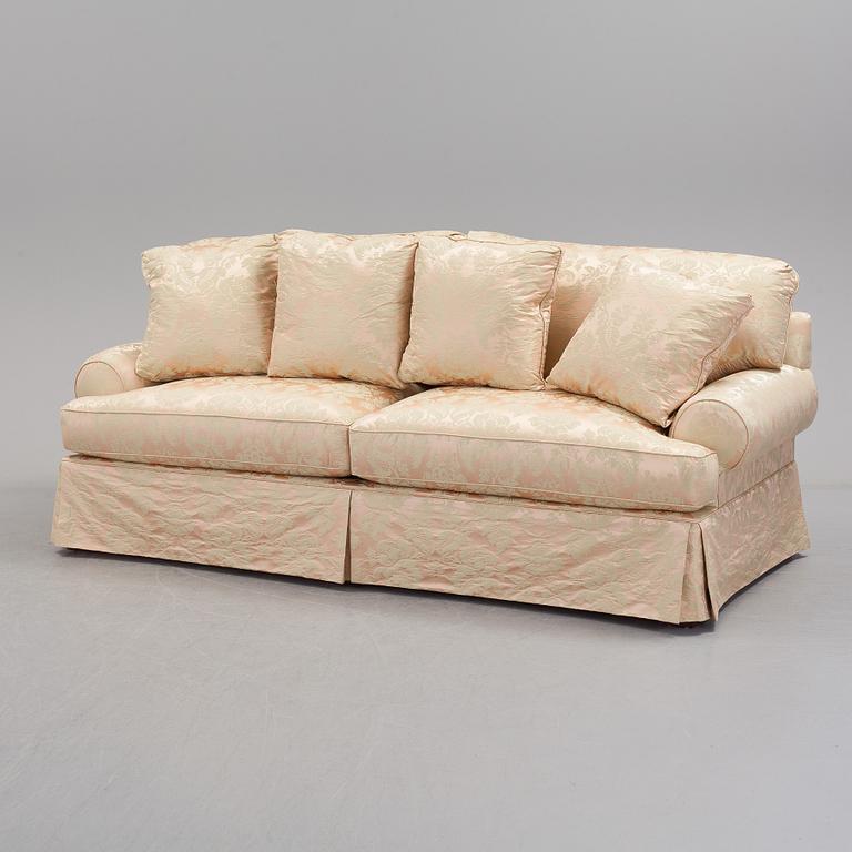 A sofa upholstered with silk damask.