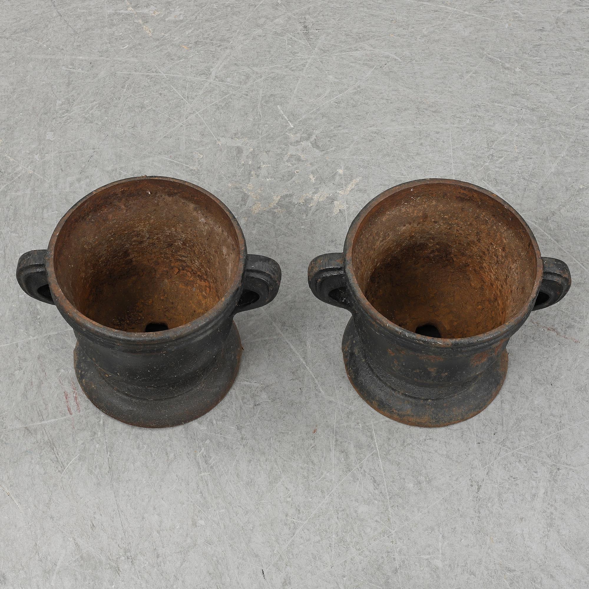 A 19th  century pair of cast iron flower pots.