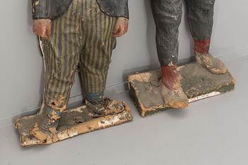 FIGURDOCKOR, ett par, Papier maché,  föreställande Fyrtornet och Släpvagnen. 1900-talets första hälft.