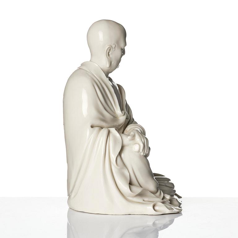 A blanc de Chine seated figure of Bodhidharma, Qing dynasty.