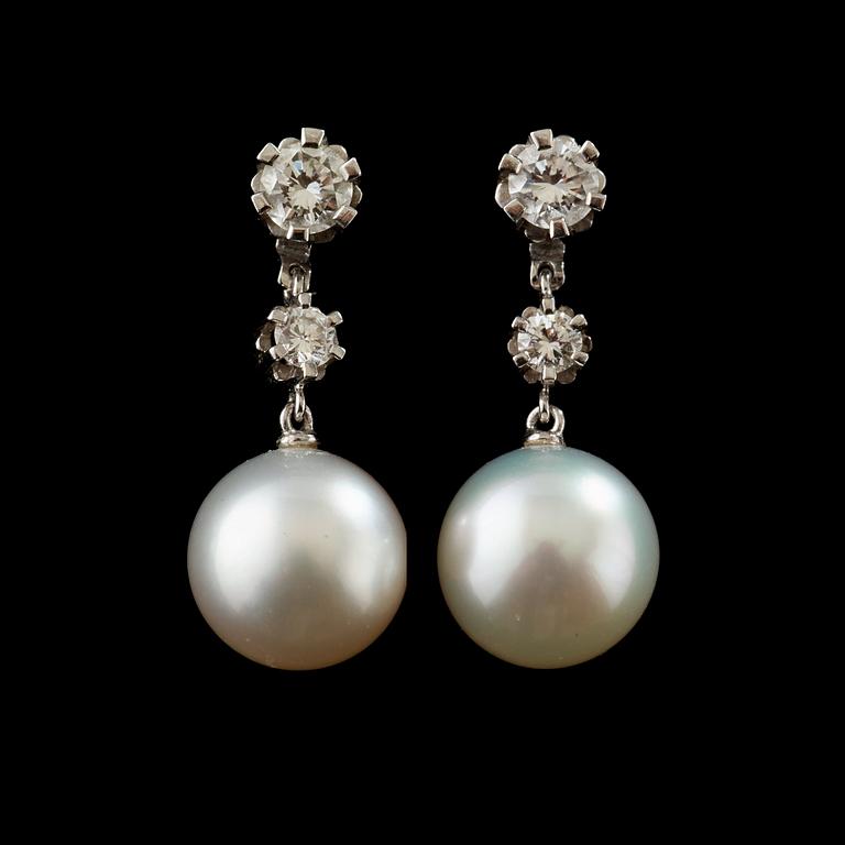 A pair of pearl and diamond earring.