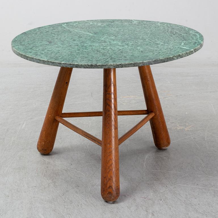 A late 20th century stone and wood coffee table.