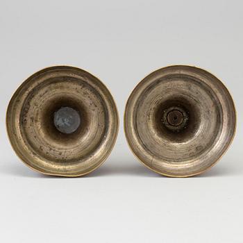 A pair of late 18th century bronze candlesticks.