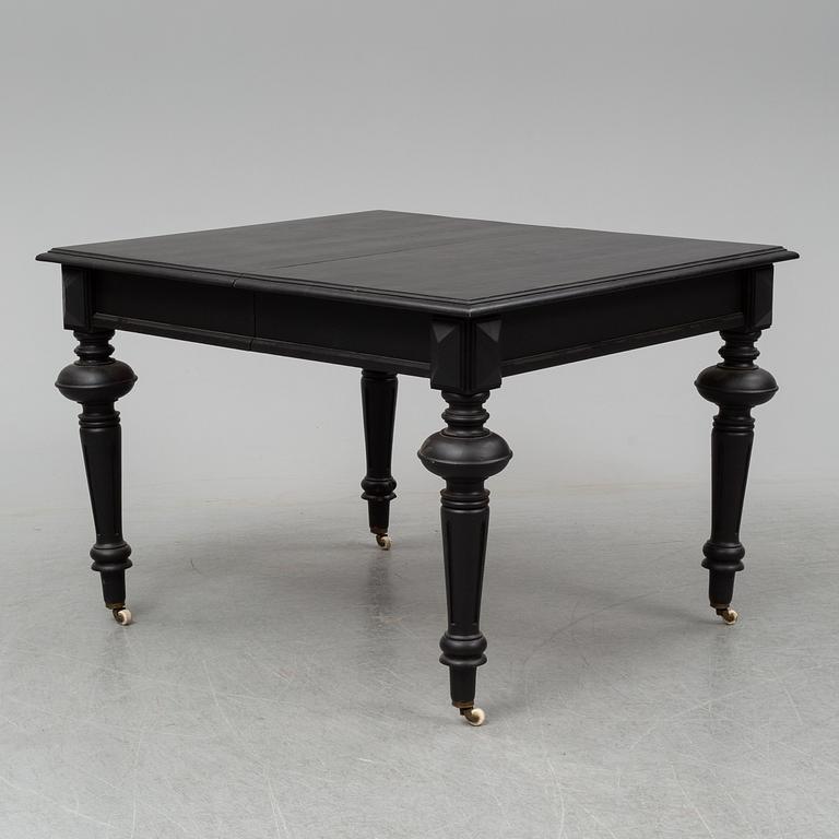 A dining table with an additional leave from around year 1900.