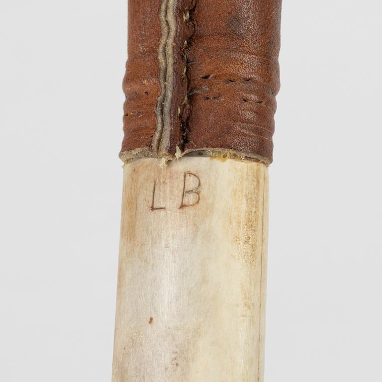 A reindeer horn knife signed LB.