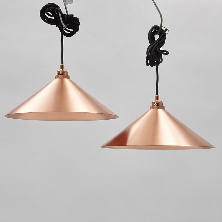 A pair of Frama Shade 360 ceiling lamps.