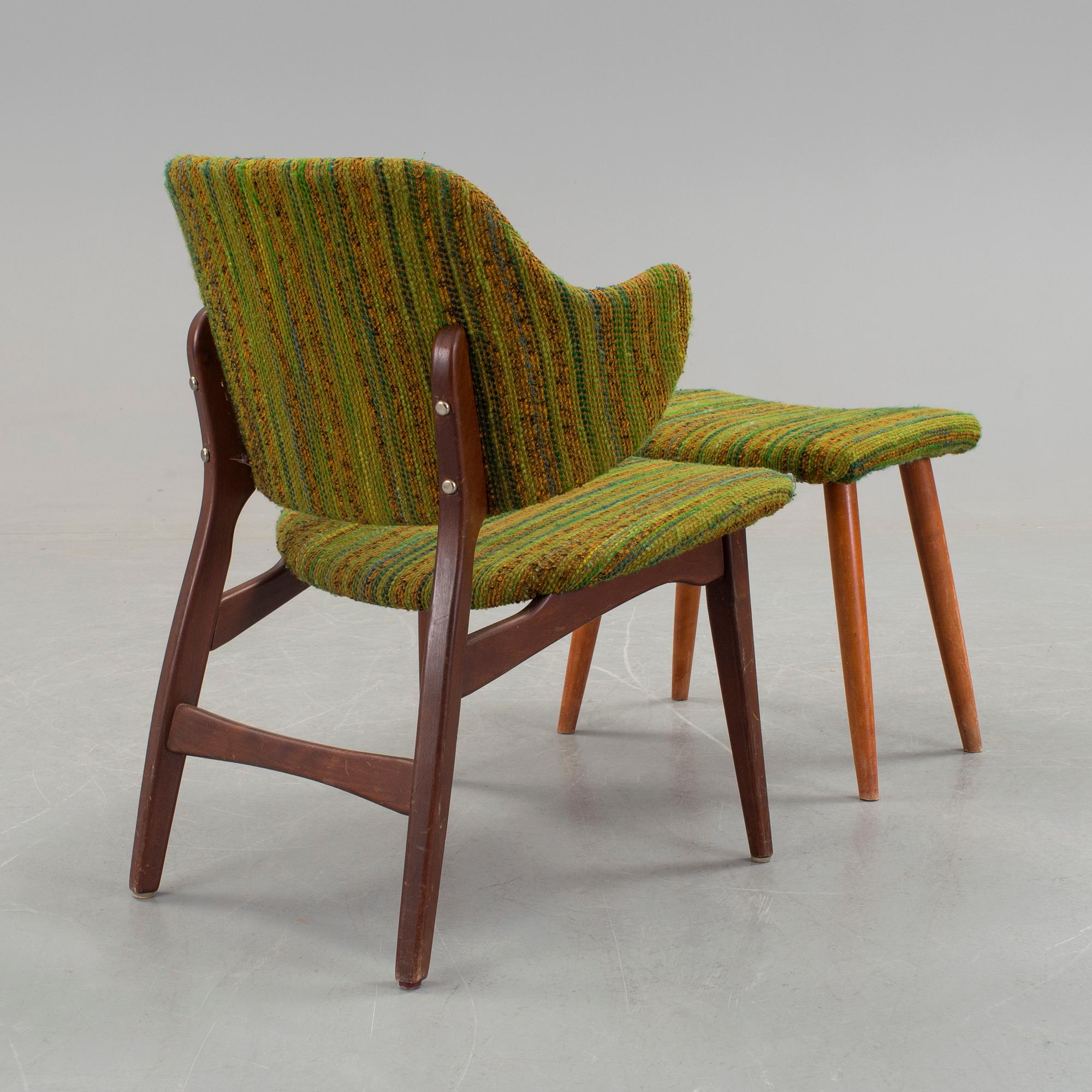 An IKEA armchair with a stool.