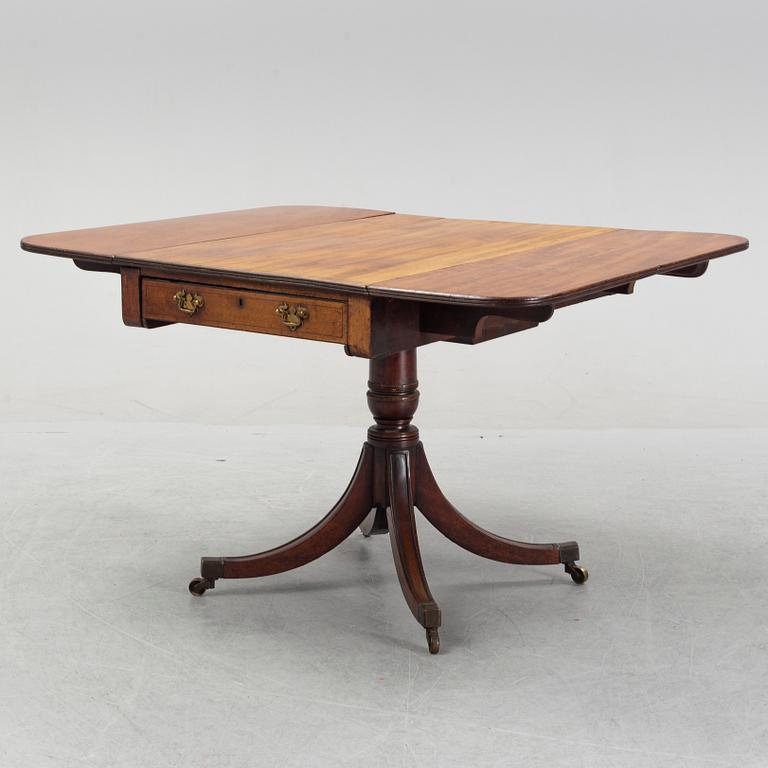 A mahognay drop leaf table, end of the 19th Century.