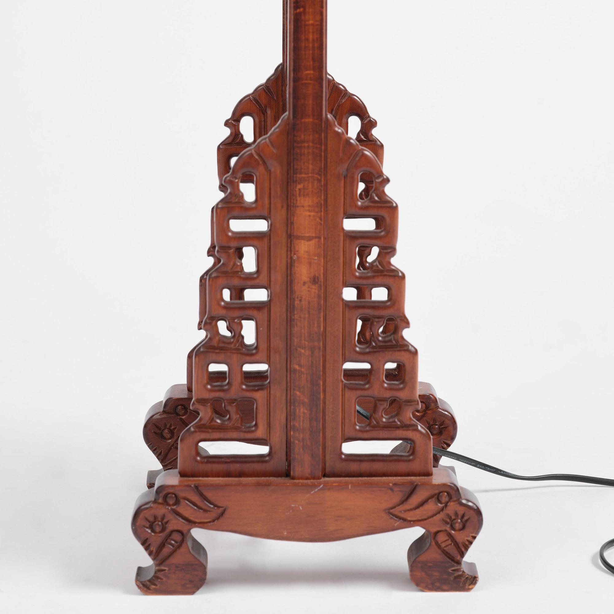 A Chinese wooden floor lamp, later part of the 20th century.