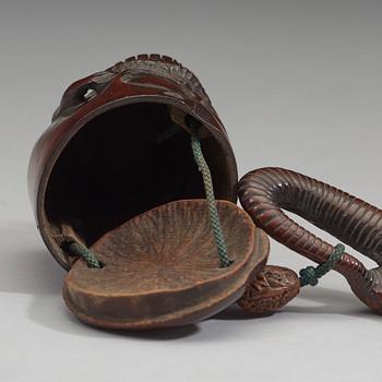 A Japanese bamboo box in the form of a skull with snake, Meiji period (1868-1912).