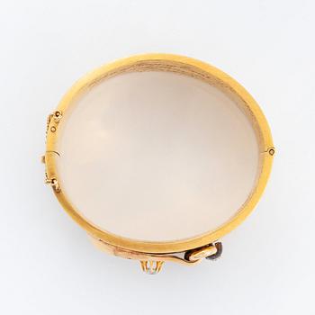 An 18K gold bangle set with old- and rose-cut diamonds.