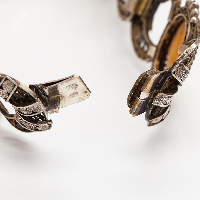 A silver and sea shell cameo bracelet.