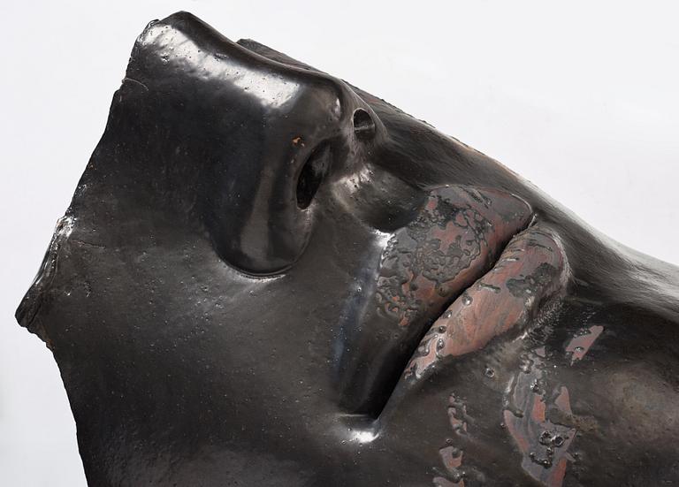 Hertha Hillfon, a black glazed stoneware wall sculpture in two parts of a face and a sky, executed in her own studio, Stockholm 1960s.