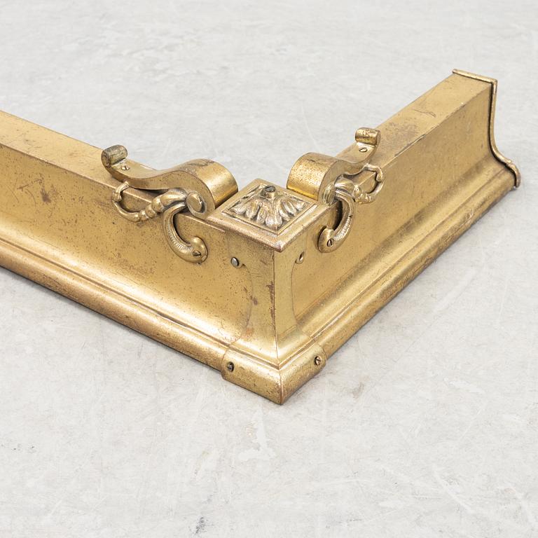 A brass fire guard, around 1900.