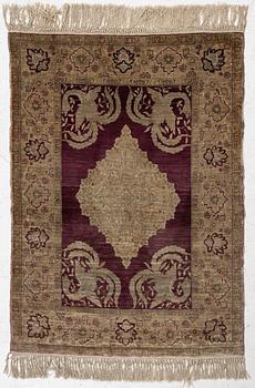 A Hereke silk rug, c. 78 x 57 cm.