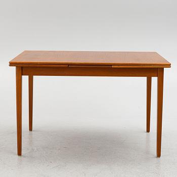 A dining table with four chairs, mid 20th century.