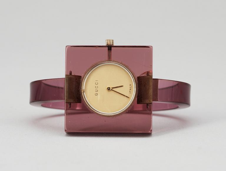 A purple plexiglass wrist-watch by Gucci.